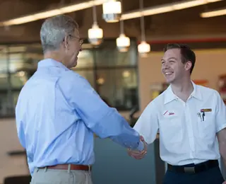 Les Schwab Employee Shaking Hands with Customer.